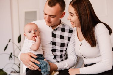 Little boy upset sad dissatisfied cute child baby playing with parents. Playful frowning eyebrows toddler with bulging big eyes, making faces grimaces. Happy childhood, family concept