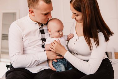 Little boy pop-eyed surprised cute child baby looking at mother breast. Playful shocked toddler with bulging big eyes having fun, making faces grimaces. Happy childhood, family concept