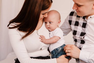 Little boy pop-eyed surprised cute child baby looking at mother breast. Playful shocked toddler with bulging big eyes having fun, making faces grimaces. Happy childhood, family concept