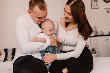 Little boy pop-eyed surprised cute child baby looking at mother breast. Playful shocked toddler with bulging big eyes having fun, making faces grimaces. Happy childhood, family concept