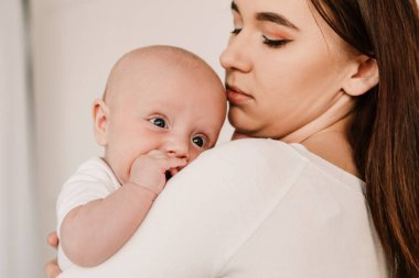 Little boy funny cute child baby, mother hold comforting the child, soothes lulling the kid. Playful toddler with bulging eyes, making faces grimaces. Happy childhood, family concept