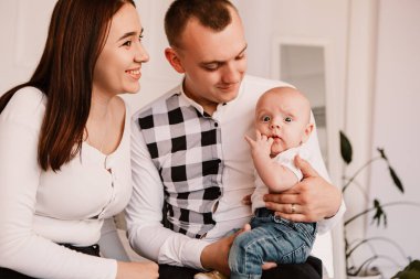 Little boy upset sad dissatisfied cute child baby playing with parents. Playful frowning eyebrows toddler with bulging big eyes, making faces grimaces. Happy childhood, family concept