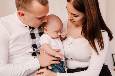 Little boy pop-eyed surprised cute child baby looking at mother breast. Playful shocked toddler with bulging big eyes having fun, making faces grimaces. Happy childhood, family concept