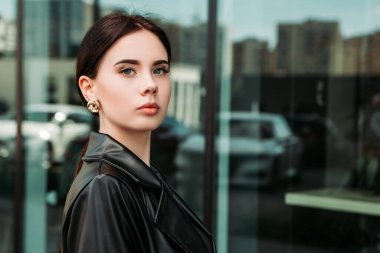 Pretty brunette caucasian woman dressed leather suit with shoulder bag walking outside street. Businesswoman hurry to work. Office CEO clerk. Confident serious lady. Professional business owner