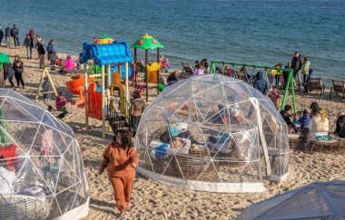 Odessa, Ukraine 02.01.2023. People relaxing in a beach restaurant on a sunny winter day