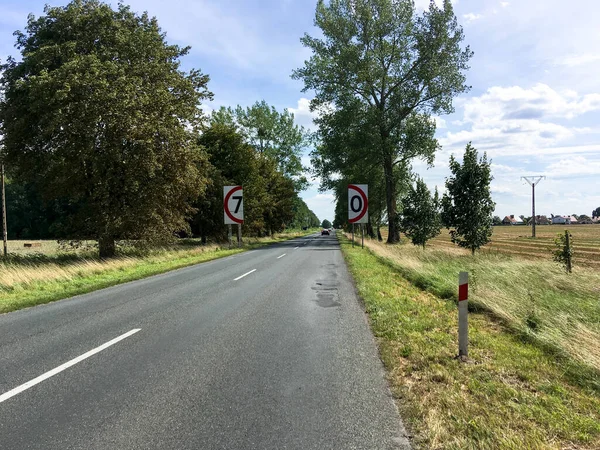 Stock image POLAND - AUGUST: countryside sliding road with bizarre speed indicator sign