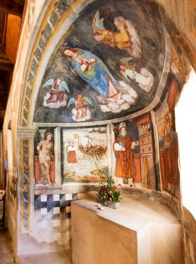 Sementina, Switzerland - december 9, 2016: Church of St. Bernard in the chestnut on Mornera. Ancient Romanesque church, in a tight angle but enriched with frescoes depicting the 