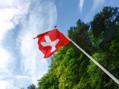 Ruetli, Switzerland: Patriotic Swiss flag with sky background