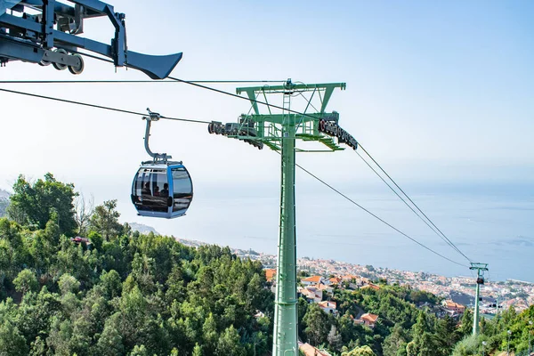 view of Funchal with traditional cable car above the city, in Madeira island vacation tourism landscape panorama.