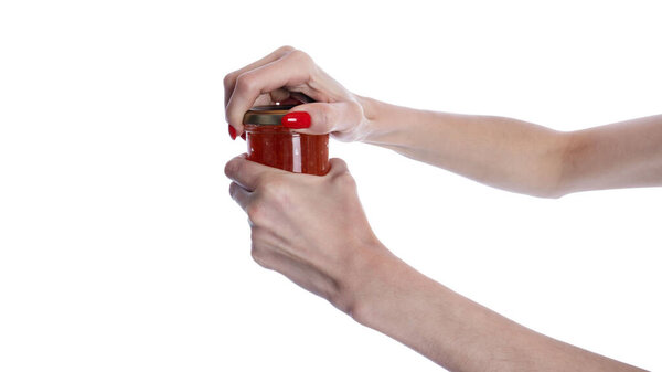 Glass jar of red caviar in hand isolated on white background. High quality photo