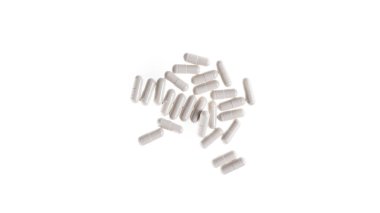 İzole edilmiş beyaz arka plandaki beyaz renkli hapların ya da kapsüllerin yakın çekimi. - Evet. Yüksek kalite fotoğraf