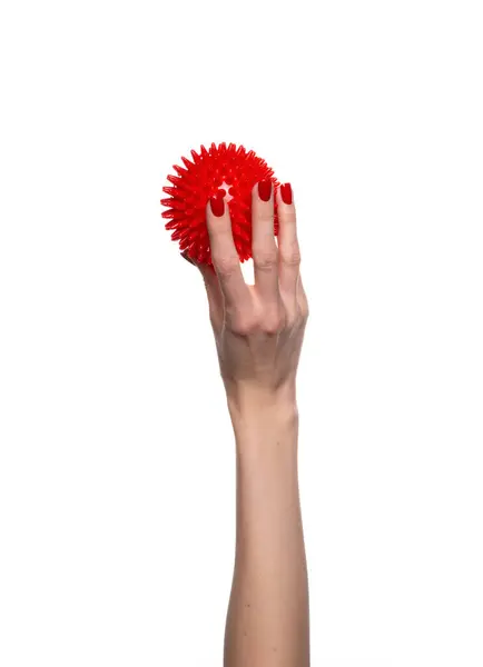 stock image Massage red ball in female hand for trigger points isolated on a white background. Concept of myofascial release. High quality photo