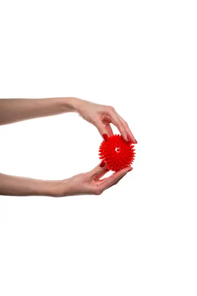 stock image Massage red ball in female hand for trigger points isolated on a white background. Concept of myofascial release. High quality photo