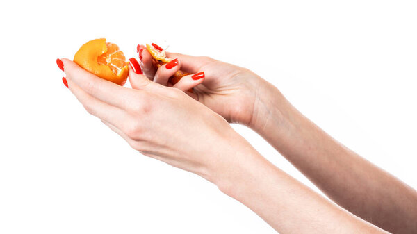 Tangerine in hand isolated on white background. High quality photo