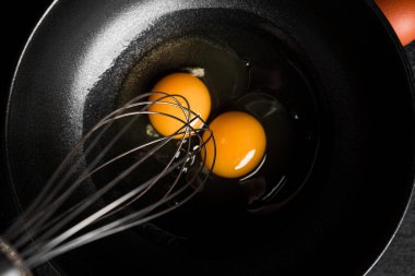 Koyu arkaplanda yumurtalar. Kırbaçlamak için çırpın. Yumurta çırpıyorum. Yüksek kalite fotoğraf