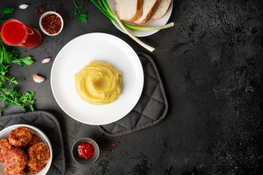 Kaburgalı patates püresi, domates suyu ve karanlık bir arka planda otlar. Yüksek kalite fotoğraf