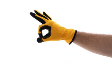 Eldivenli bir el beyaz bir arka plana karşı iyi bir hareket yapar. Eldiven parlak sarı, iş ya da açık hava aktiviteleri için uygundur, bu da olumlu bir onay ya da onay demektir..