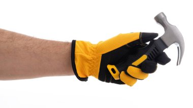 Bir insan eldivenli bir elle çekici sıkıca tutuyor. Konferansta, yaklaşmakta olan inşaat veya onarım görevlerine hazırlık durumlarını vurgulayan el ve araç üzerinde duruluyor. Ayarlar tarafsız ve basit..