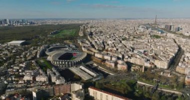 Paris, Fransa 'daki modern bir spor stadyumunun kuş bakışı görüntüsü. Bir İHA bir spor tesisinin üzerinde uçuyor. Şehir merkezinin ve çatıların havadan görüntüsü. Yüksek kalite 4k görüntü