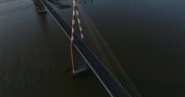 Kablo destekli Fransız köprüsünün üzerinde uçuyor. İnanılmaz bir gün doğumu. Saint Nazaire Köprüsü 'nün havadan görünüşü Fransa' nın Loire nehri boyunca uzanan bir köprü olarak kaldı..