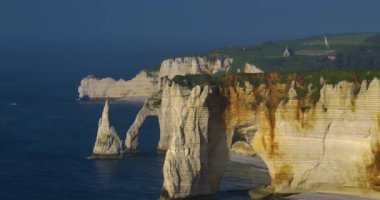 Bir İHA Fransa 'nın Etretat kentindeki tebeşir uçurumlarıyla kıyı şeridinde uçuyor. Atlantik Okyanusu 'nun kıyısındaki resim gibi bir yerin havadan görünüşü. Kayalar, uçurumlar, tepeler bir İHA 'dan kaydedilmiş..