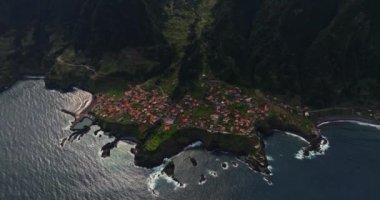 Yıllar önce sızan volkanik kayanın üzerindeki Seixal kasabasının insansız hava aracı görüntüsü inanılmazdı. Portekiz 'in Madeira şehrinde küçük bir belediye.