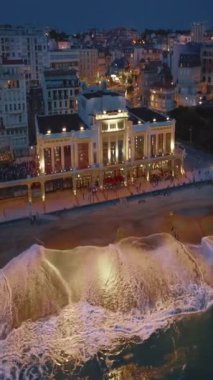 Geceleri Biarritz şehrinin inanılmaz güzel hava manzarası. Gece ışıklarıyla aydınlatılan okyanus dalgaları gece turistlerinin sahillerini yıkıyor. Fransa.