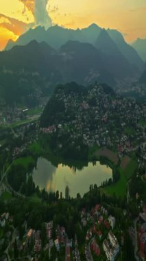 Lugano şehrinin havadan görünüşü ve San Salvatore dağından Lugano Gölü. İsviçre, Canton Ticino 'daki Lugano şehrine bakan Monte Bre' nin hava görüntüleri..