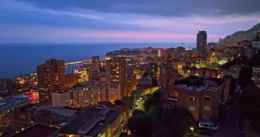 Aydınlatılmış şehir binalarının havadan çekim görüntüleri. Monte Carlo, Monaco 'daki yerleşim şehrindeki aydınlık gökdelenin hava manzarası..