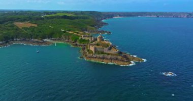 La Latte Kalesi 'nin havadan görünüşü, Cap Frehel, Brittany, Fransa' daki Chateau de la Roche Guyon kumtaşı kayalıklarında dalgaların ezdiği güneşli bir yaz gününde.
