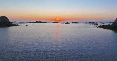 Gün batımında Fransa 'daki Atlantik Okyanusu' nun inanılmaz kayalık kıyılarının havadan görüntüsü. Bretagne 'ın fotoğrafını çekiyorum. Kuzey Brittany 'de kayaların üzerinden uçan ve onlara çarpan bir dron..