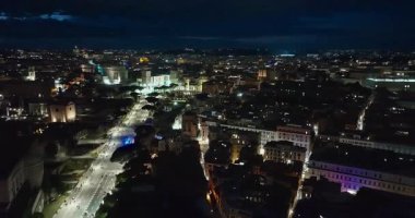 Geceleri Colosseum 'un uçan insansız hava aracını kuruyorum. Kolezyum mimari aydınlatmayla aydınlatıldı. Roma şehir merkezi, İtalya. Kolezyum ve Roma 'daki İmparatorluk Forumları.