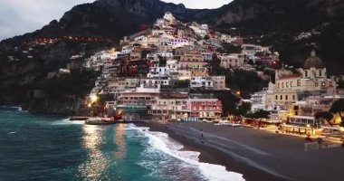 Positano 'nun havadan görünüşü. Gece vakti ışık saçan ünlü renkli evler. İtalya, Amalfi Sahili 'nde muhteşem bir mimari..