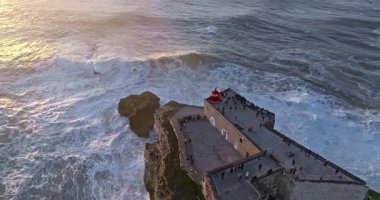Nazare Deniz fenerinin hava manzarası. Dünyanın en büyük dalgaları çarpıcı deniz fenerinin kayalarına çarpıyor. Portekiz.