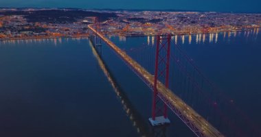 Gece vakti köprüde giden arabaların hava görüntüsü. Lizbon 'daki Tagus nehri üzerindeki asma köprü. Portekiz.