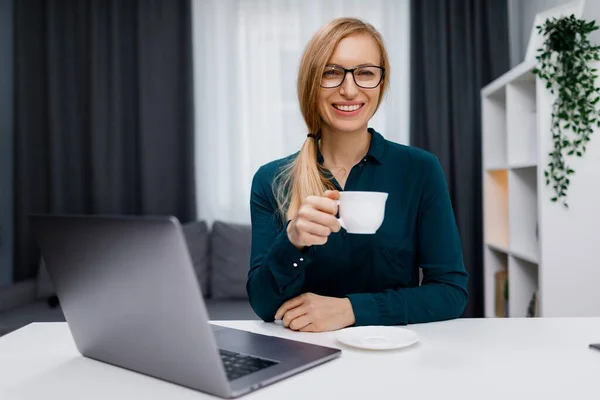 Evde Kablosuz Bilgisayarla Çalışırken Gözlüklü Kahve Içen Olgun Bir Kadın — Stok fotoğraf