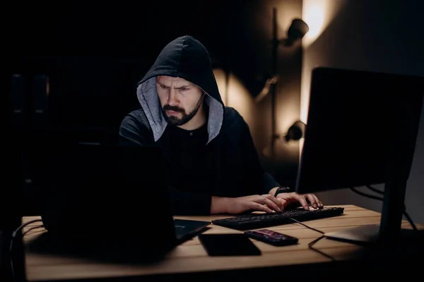 후드를 집중적 해커가 어두운 방에서 컴퓨터를 연구하고 있습니다 사이버 공격을 — 스톡 사진
