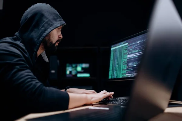 베어링의 후드의 사이버 범죄를 저지르는 동안어두운 장소에 있습니다 현대의 컴퓨터를 — 스톡 사진