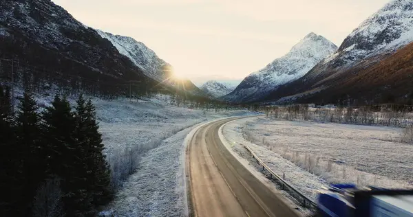 stock image Vital Arctic Logistics: The Essential Role of Lorry Transportation on Norways Snow-Covered Mountain Roads in Winter. High quality 4k footage