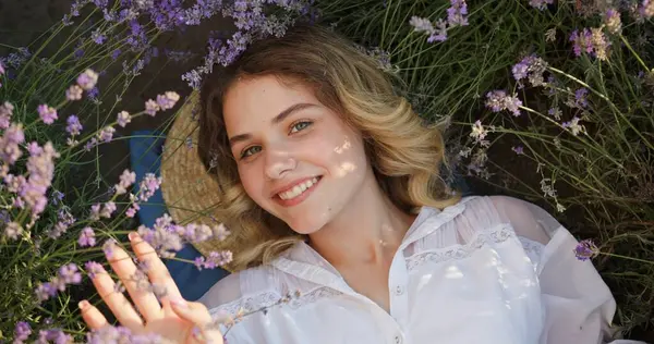 stock image Blissful Young Woman Lying in Lavender Field, Gazing Up with a Joyful Smile. High quality 4k footage