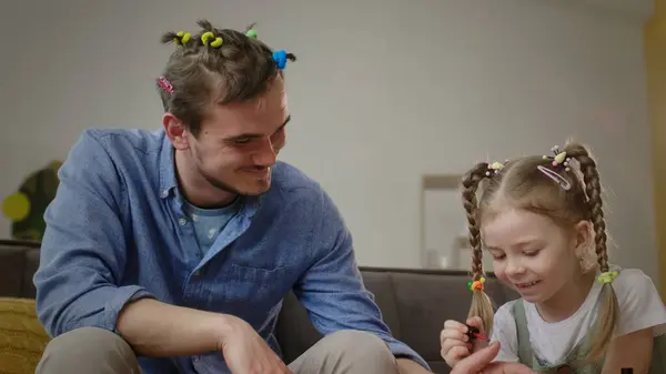 stock image Cheerful Dad Observes Daughter Giving Him a Nail Polish Session at Home. High quality 4k footage