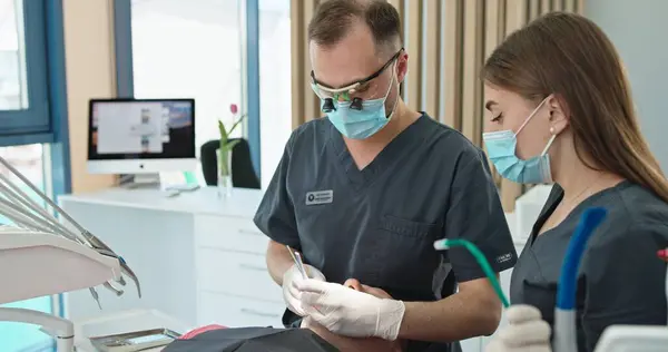 stock image Dentist and Assistant Conducting Dental Procedure in Modern Clinic. High quality 4k footage