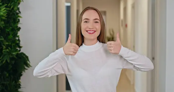 stock image Enthusiastic Approval: Young Woman Giving Thumbs Up in Office Hallway. High quality 4k footage