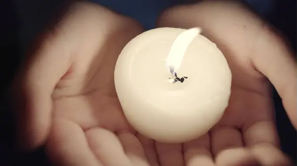 stock image Portrait of the girl with a candle in hands. The spirituality face . Mood of sacrament and revelation.