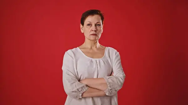 stock image Cheerful Greeting: Joyful Mature Woman on Red Background. High quality 4k footage