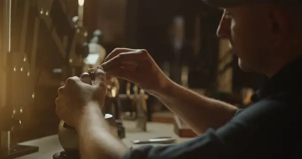 stock image Jeweler Working on Attaching a Ring in Warmly Lit Workshop. High quality 4k footage