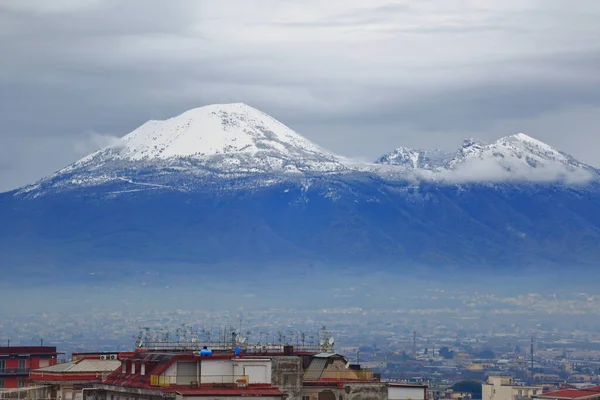 Pagani, Salerno, Italy- January 21,2023 : Snowfall on Vesuvius after days of heavy rain and temperatures in sharp decline. Overview of the Volcano from different points of the city.