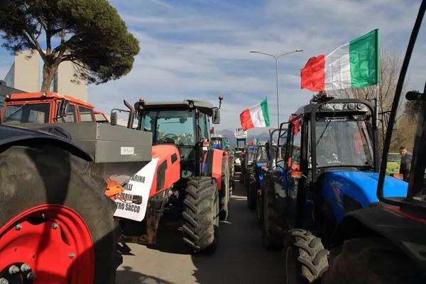 Avellino, İtalya-Şubat 07.2024: Bir grup çiftçi Avrupa Topluluğu 'nun tarım politikalarını protesto ediyor. Şehrin sokaklarında traktörleriyle yürüyorlar. .