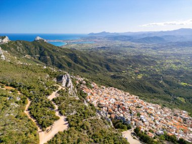 Picturesque village in the mountains of Baunei in Italy, in the region of Sardinia, in the province of Nuoro, aerial view from drone clipart