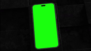 Dalgalı bir akışkan yüzey üzerinde süzülen yeşil ekranlı akıllı telefon, modern teknolojiyi gösteriyor.